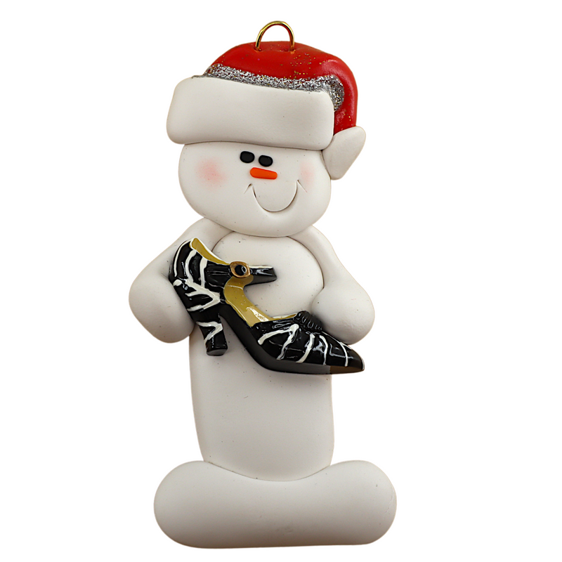Ornament of white snowman in red hat holding a fancy shoe.