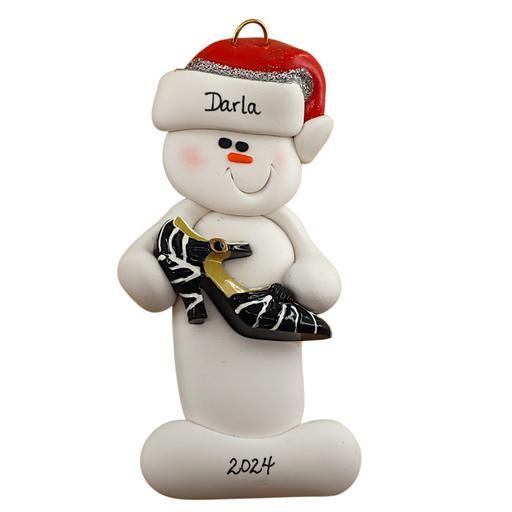 Ornament of white snowman in red hat holding a fancy shoe, personalized with name.