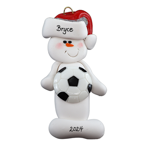 Ornament of white snowman in red hat holding a soccer ball, personalized with name.