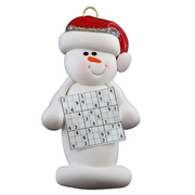 Ornament of white snowman in red hat holding a sudoku page.