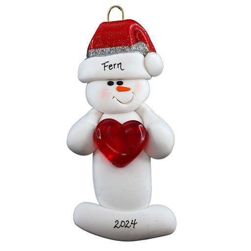 Ornament of white snowman in red hat holding a shiny red heart, personalized with name.