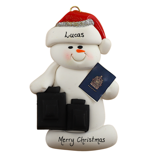 Ornament of white snowman in red hat holding a passport and suitcases, personalized with name.