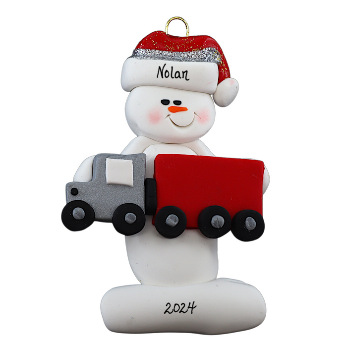 Ornament of white snowman in red hat holding a red semi truck, personalized with name.