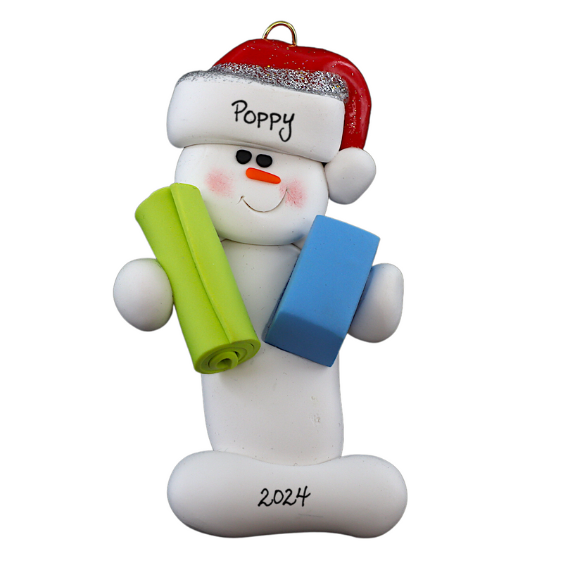 Ornament of white snowman in red hat holding vibrant yoga mat and block, personalized with name.