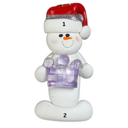 Ornament of white snowman in red hat holding purple plastic crown, numbered 1-2 for personalization.