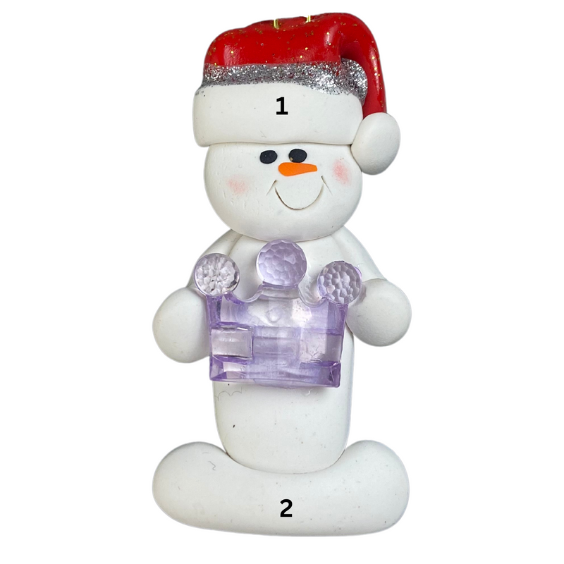 Ornament of white snowman in red hat holding purple plastic crown, numbered 1-2 for personalization.