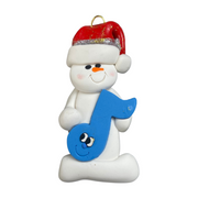 Ornament of white snowman in red hat holding a blue music note.