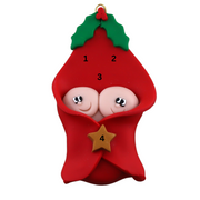 Ornament with twin infant heads poking out of a red baby blanket, numbered 1-4 for personalization.