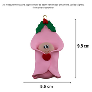 Ornament with an infant head poking out of a pink baby blanket, graphed to show size (5.5x9.5cm).