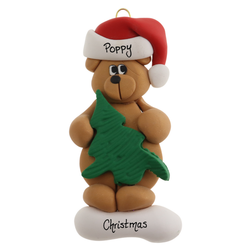 Tan bear in red festive hat holding green tree ornament, personalized with name.