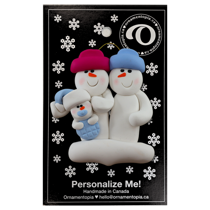 Family ornament with 2 large and 1 infant snowman in blue, on display backing card.