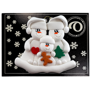 Family ornament with 2 large and 1 small snowmen in hats, holding holiday objects, on display backing card.