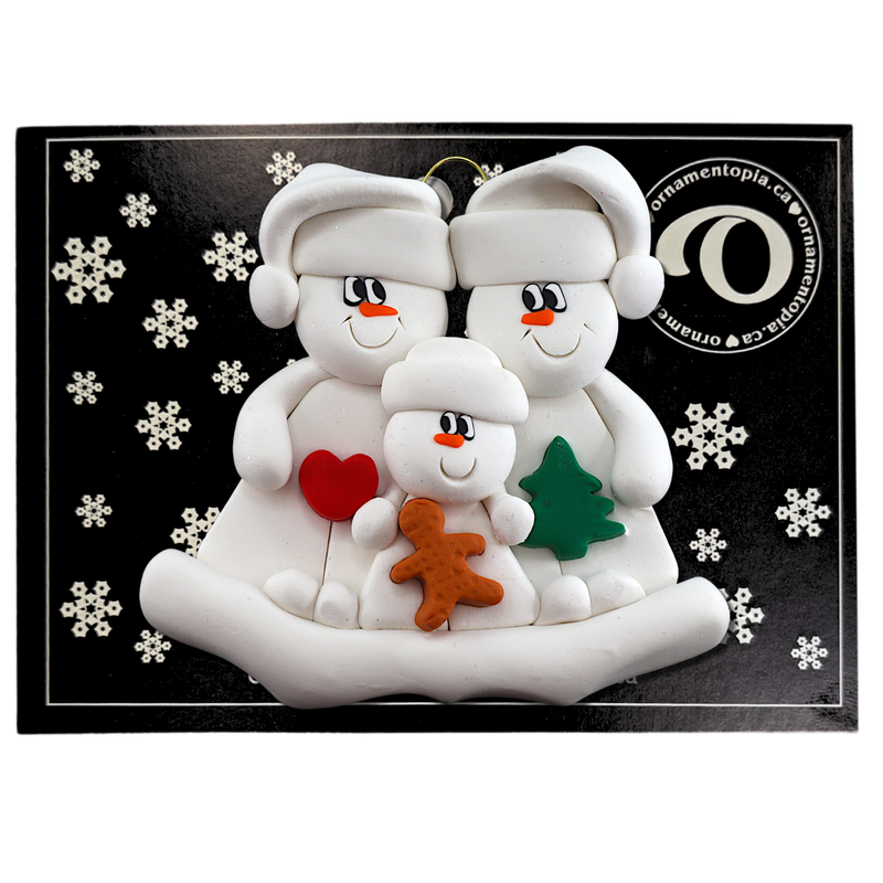 Family ornament with 2 large and 1 small snowmen in hats, holding holiday objects, on display backing card.