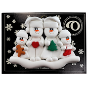 Family ornament with 2 large and 2 small snowmen in hats, holding holiday objects, on display backing card.