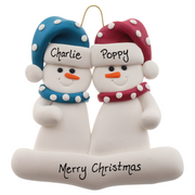 A couple’s ornament of two white snowmen in polka dot scarves and hats, personalized with names.