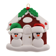 A couple’s ornament of two small white snowmen beside a festive brown house.