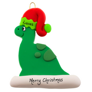Green dinosaur wearing red festive hat ornament, personalized with name.