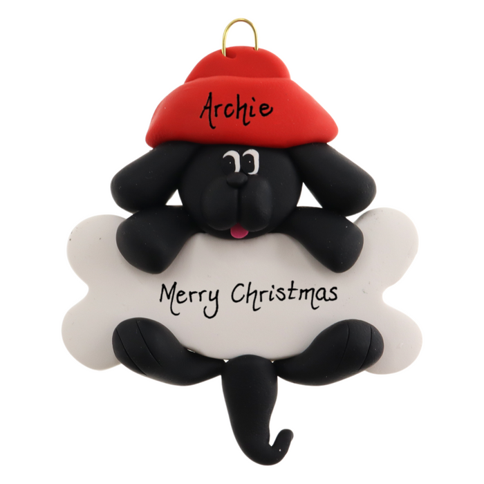 Ornament of black dog in red hat hanging on a white bone, personalized with names.