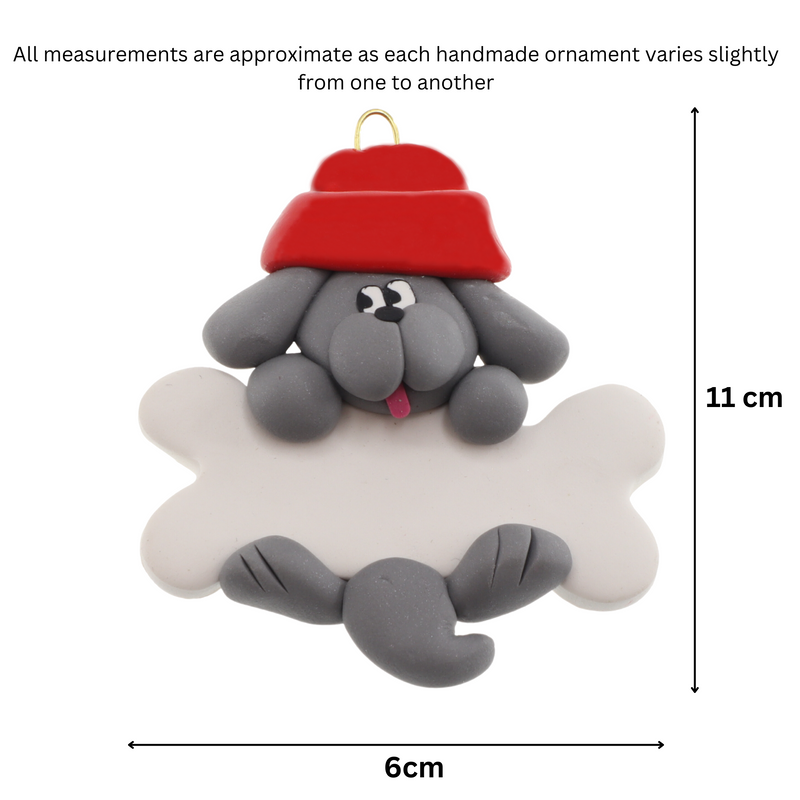 Ornament of grey dog in red hat hanging on a white bone, graphed to show size (6x11cm).