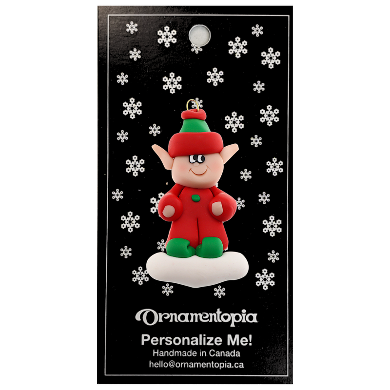 Red and green elf ornament, on display backing card.