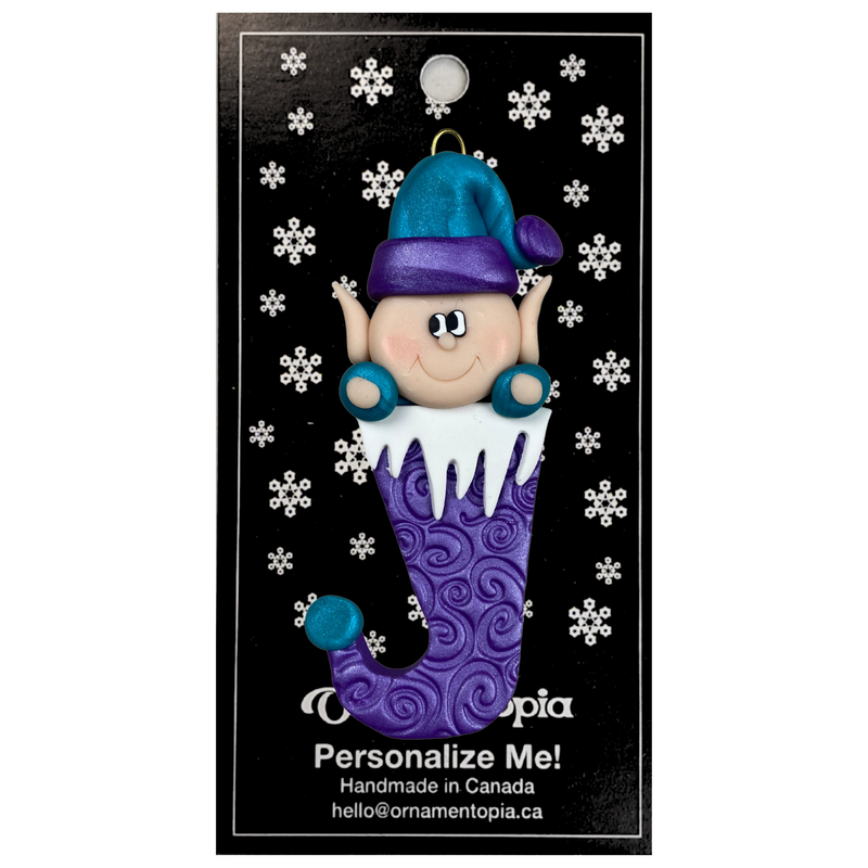 Elf poking out of purple stocking ornament, on display backing card.