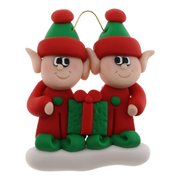 A couple’s ornament with two small red and green elves with a matching present.