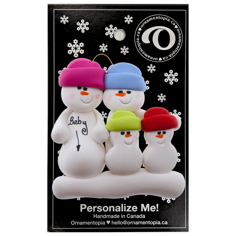 Family ornament with 4 snowmen in bright hats, one pregnant, on display backing card.