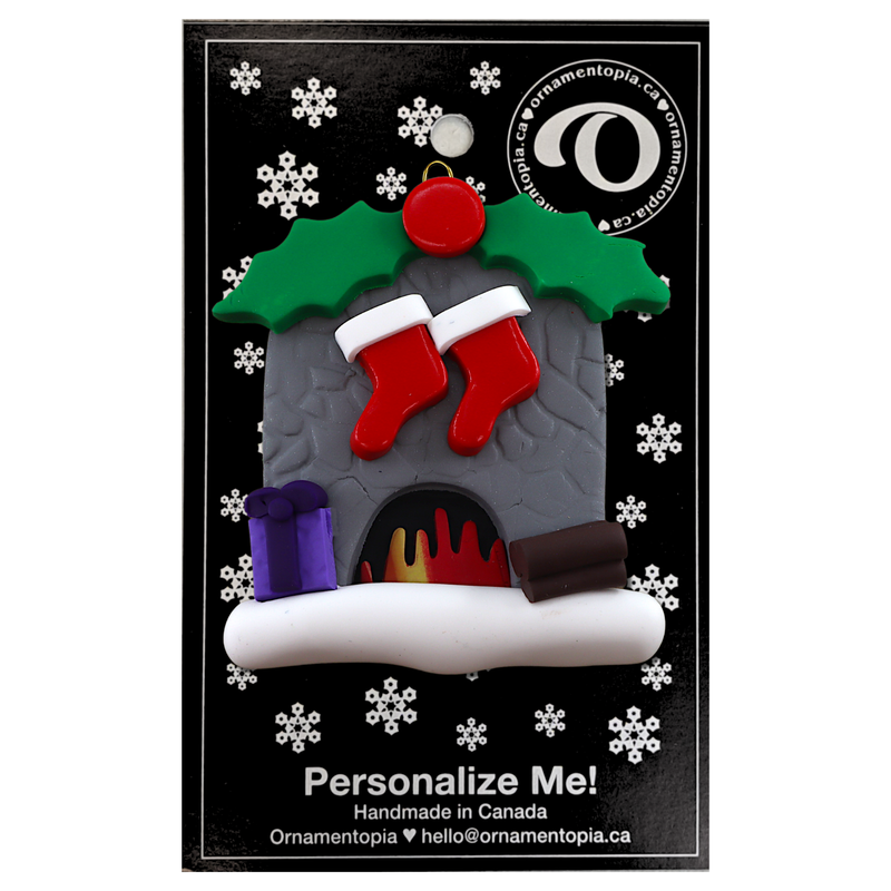 Vibrant fireplace ornament with holly and Christmas presents, displaying 2 red stockings, on display backing card.