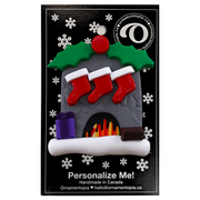 Vibrant fireplace ornament with holly and Christmas presents, displaying 3 red stockings, on display backing card.