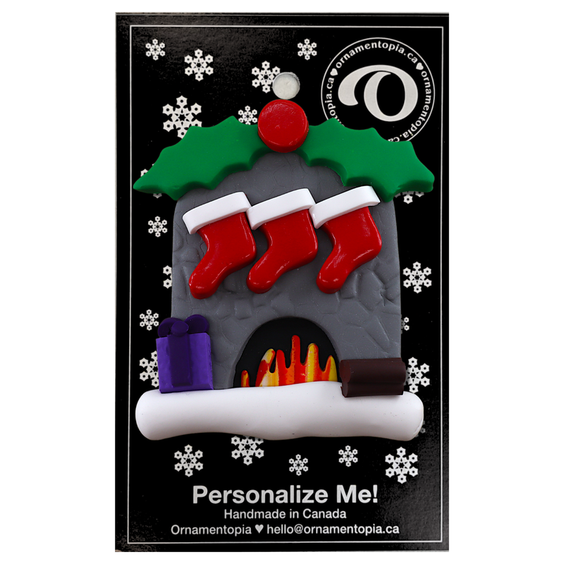 Vibrant fireplace ornament with holly and Christmas presents, displaying 3 red stockings, on display backing card.