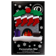 Vibrant fireplace ornament with holly and Christmas presents, displaying 4 red stockings, on display backing card.