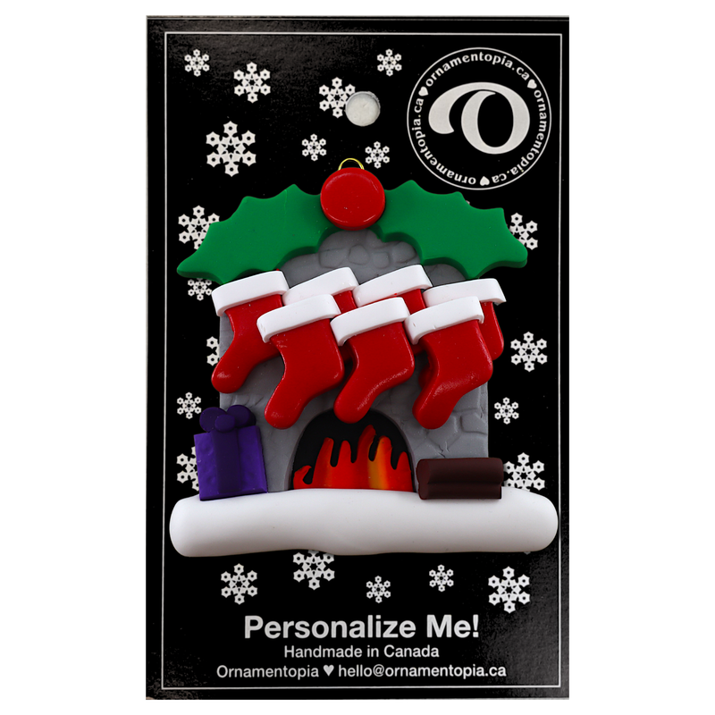 Vibrant fireplace ornament with holly and Christmas presents, displaying 7 red stockings, on display backing card.