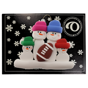 Family ornament with 4 white snowmen in bright hats with a football, on display backing card.