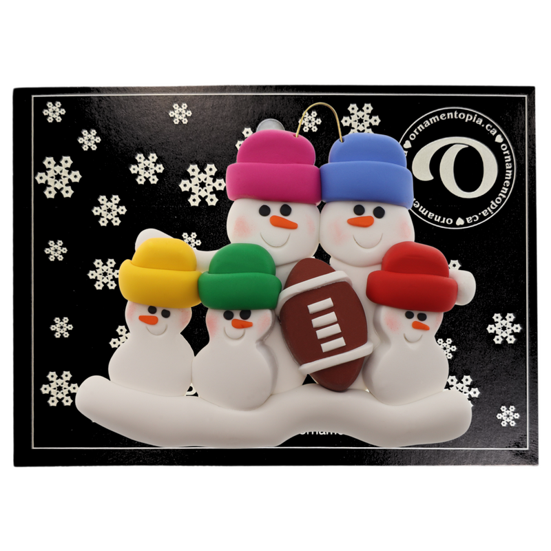 Family ornament with 5 white snowmen in bright hats with a football, on display backing card.