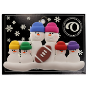 Family ornament with 6 white snowmen in bright hats with a football, on display backing card.