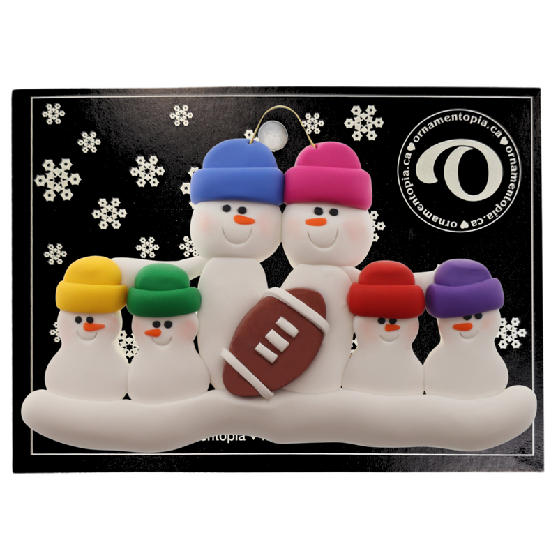 Family ornament with 6 white snowmen in bright hats with a football, on display backing card.