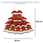 Family ornament with 11 brown gingerbread figures in red Christmas hats, graphed to show size (18x14.5cm).