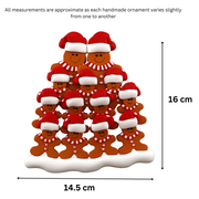 Family ornament with 13 brown gingerbread figures in red Christmas hats, graphed to show size (14.5x16cm).
