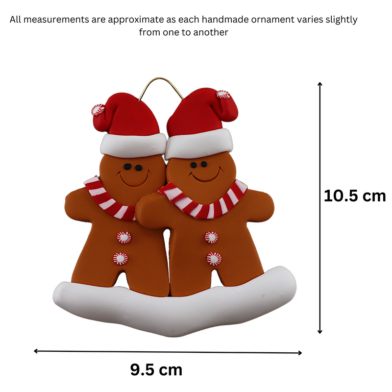 Family ornament with 2 brown gingerbread figures in red Christmas hats, graphed to show size (9.5x10.5cm).