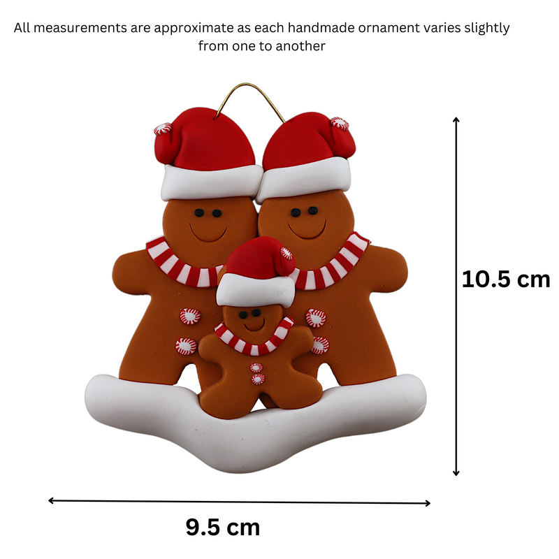 Family ornament with 3 brown gingerbread figures in red Christmas hats, graphed to show size (9.5x10.5cm).