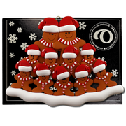 Family ornament with 11 brown gingerbread figures in red Christmas hats, on display backing card.
