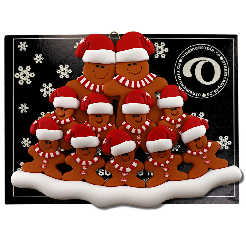 Family ornament with 11 brown gingerbread figures in red Christmas hats, on display backing card.