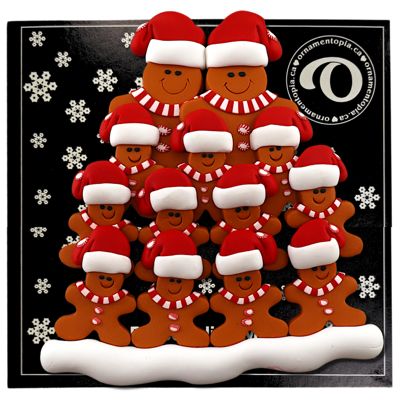 Family ornament with 13 brown gingerbread figures in red Christmas hats, on display backing card.
