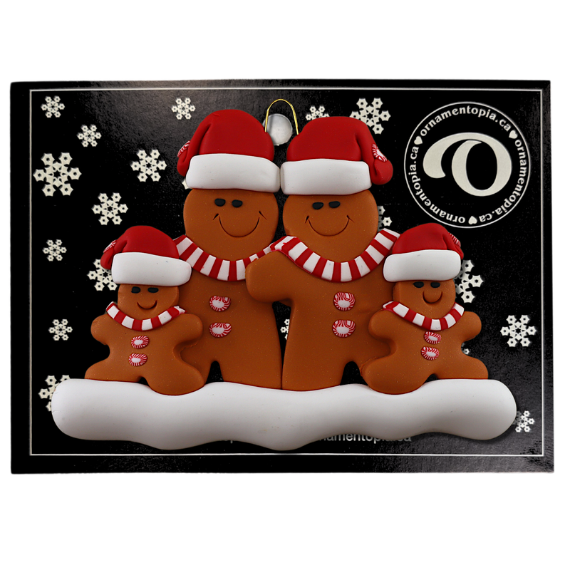 Family ornament with 4 brown gingerbread figures in red Christmas hats, on display backing card.