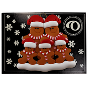 Family ornament with 5 brown gingerbread figures in red Christmas hats, on display backing card.