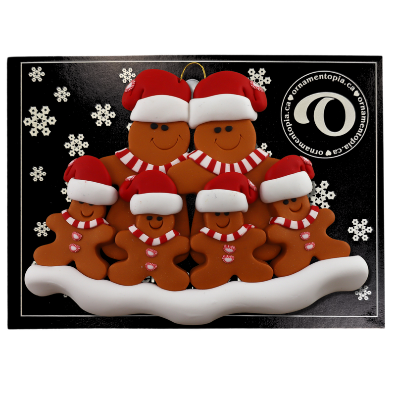 Family ornament with 6 brown gingerbread figures in red Christmas hats, on display backing card.
