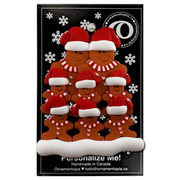 Family ornament with 8 brown gingerbread figures in red Christmas hats, on display backing card.