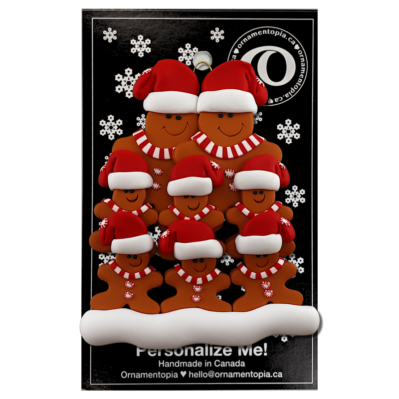 Family ornament with 8 brown gingerbread figures in red Christmas hats, on display backing card.