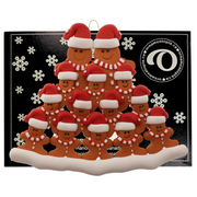 Family ornament with 14 brown gingerbread figures in red Christmas hats, on display backing card.