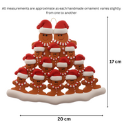 Family ornament with 14 brown gingerbread figures in red Christmas hats, graphed to show size (20x17cm).